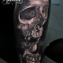 Lifelike breathtaking tattoo of big human skull and rose