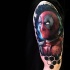 Lifelike colored shoulder tattoo of Deadpool with ornaments