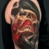 Lifelike realism style shoulder tattoo of human skull with snake