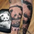 Lifelike very beautiful cute forearm tattoo of baby panda with lettering