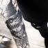 Linework style black ink forearm tattoo of evil scarecrow