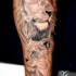 Tatuaje de león y leona en la pierna
