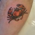 piccolo granchio rosso con un occhio grande tatuaggio
