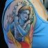 Tatuaggio colorato sul braccio divina Krisshna