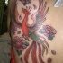 Lovely flying phoenix and flowers tattoo on back