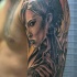 Magnificent angel woman with pistol tattoo on shoulder