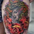 Magnificent looking colored modern style Medusa portrait tattoo on thigh with old style rose flowers