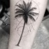 Tatuaje  de palmera simple gris  en el antebrazo