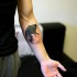 Marvelous black and white forearm tattoo of roaring bears