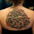 Marvelous black and white upper back tattoo of dragon with flames