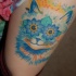 Marvelous bright colored cat with flowers eyes designed thigh tattoo