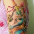 Tatuaje colorido en el brazo, unicornio maravilloso  con mariposa