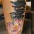 Medium black ink old Asian temple tattoo on leg combined with colored flower