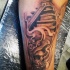 Medium size black and white arm tattoo of tribal skull and temple