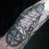 Medium size stippling style sleeve tattoo of lighthouse and compass