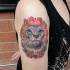 Mexican traditional colored shoulder tattoo of cat with flowers