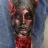 Mexican traditional style colored arm tattoo of woman face with rose
