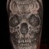 Mexican traditional style colored arm tattoo of human skull with flowers