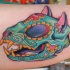 Mexican traditional style colored biceps tattoo of fantasy cat skull with flowers