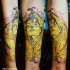 Mexican traditional style colored forearm tattoo of woman with flowers and skeleton hand