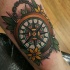 Modern style colored tattoo of compass with chain and flowers
