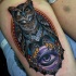 Modern style colored thigh tattoo of amazing owl with magical orb