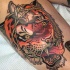 Modern style interesting looking colored tattoo of evil tiger head with roped mouse