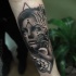 Modern traditional black and white forearm tattoo of woman with long nails and mystic symbols