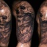 Modern traditional black and white mystical woman with helmet made from human skull tattoo on shoulder with rose