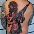 Modern traditional colored sexy woman with AK gun tattoo on back