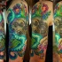 Modern traditional colored shoulder tattoo of mystical monster with human skull and flowers