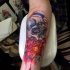 Modern traditional style colored arm tattoo of human skull with flowers