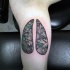 Modern traditional style colored human lungs tattoo with corrupted leaves