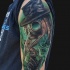 Modern traditional style colored shoulder tattoo of fantasy man with mask and green fox