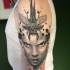 Modern traditional style detailed shoulder tattoo of woman face with big bug