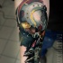 Moderne style colored forearm tattoo of Star Wars pilot with X-Wing