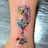 Multicolored ankle tattoo of small glass
