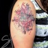 Multicolored shoulder tattoo of globe with lettering