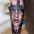 Mysterious black and white forearm tattoo of woman portrait combined with angel and Big Ben