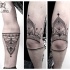 Mysterious black ink arm tattoo of mystical ornament