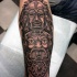 Tatuaje en el antebrazo, tótem 
 indio misterioso de colores negro y blanco