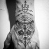 Mystical black ink hand tattoo of raccoon head with symbols