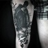Mystical black ink thigh tattoo of creepy figure with berries