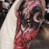 Mystical colored shoulder tattoo of demonic woman with flowers