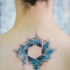 Mystical colored upper back tattoo of circle shaped symbol