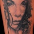 Mystical looking black ink woman face tattoo