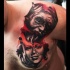 Mystical looking chest and shoulder tattoo of creepy monster with beautiful woman