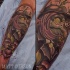 Mystical looking colored arm tattoo of fantasy bird