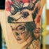 Mystical looking colored thigh tattoo of woman with deer and flowers