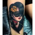 Mystical looking colored thigh tattoo of woman with sun glasses and rose